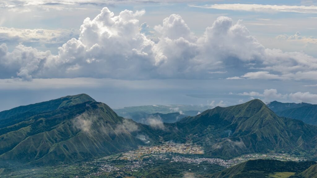 a view of a mountain range with clouds in the sky